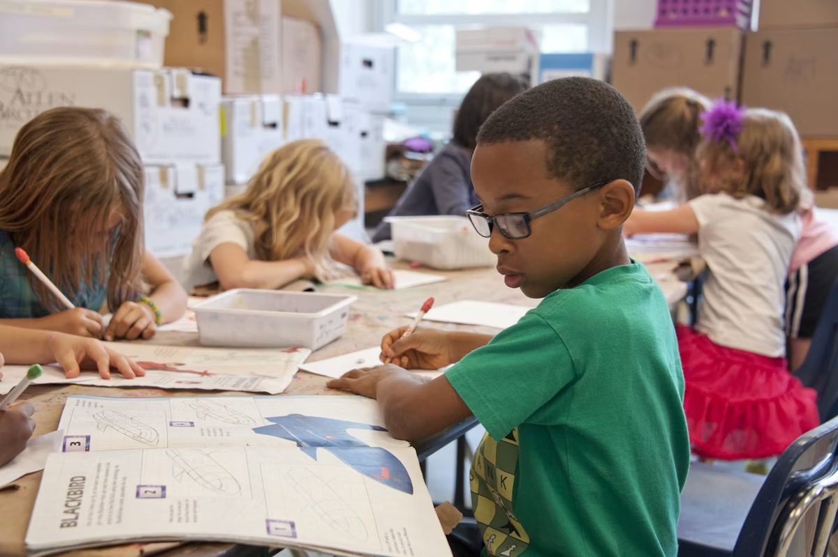 Students in a modern classroom using digital learning tools